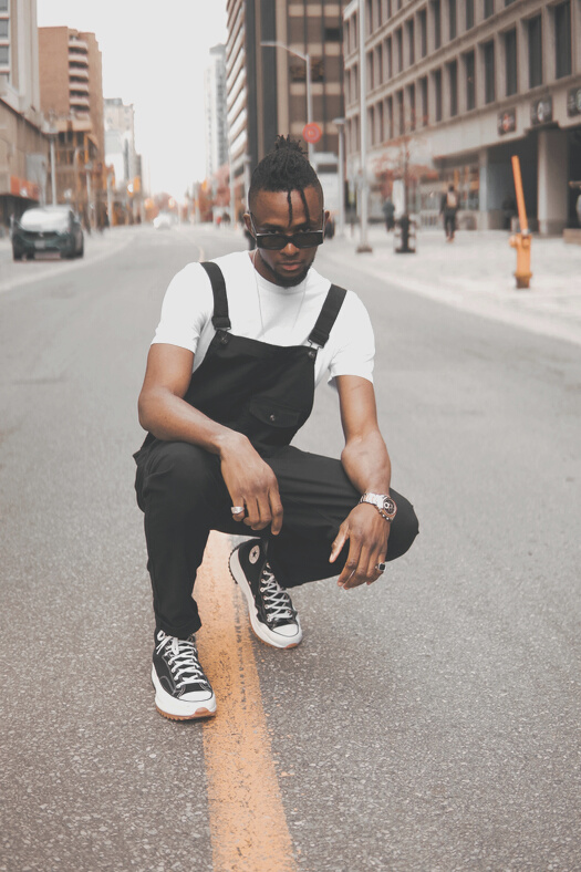 A Fashionable Man in Streetwear Posing on the Street