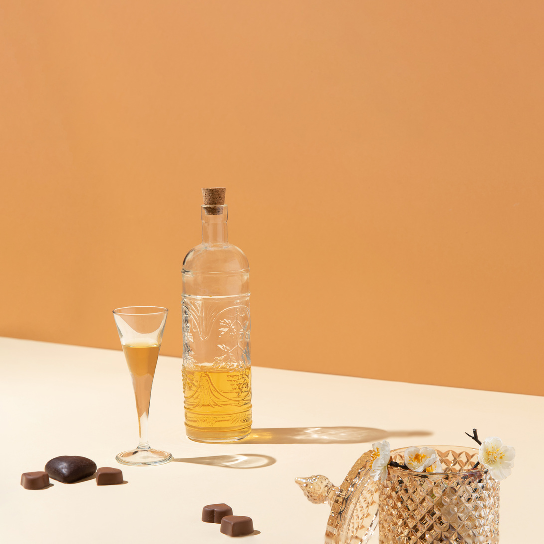 Bottle with cork and glass on the table
